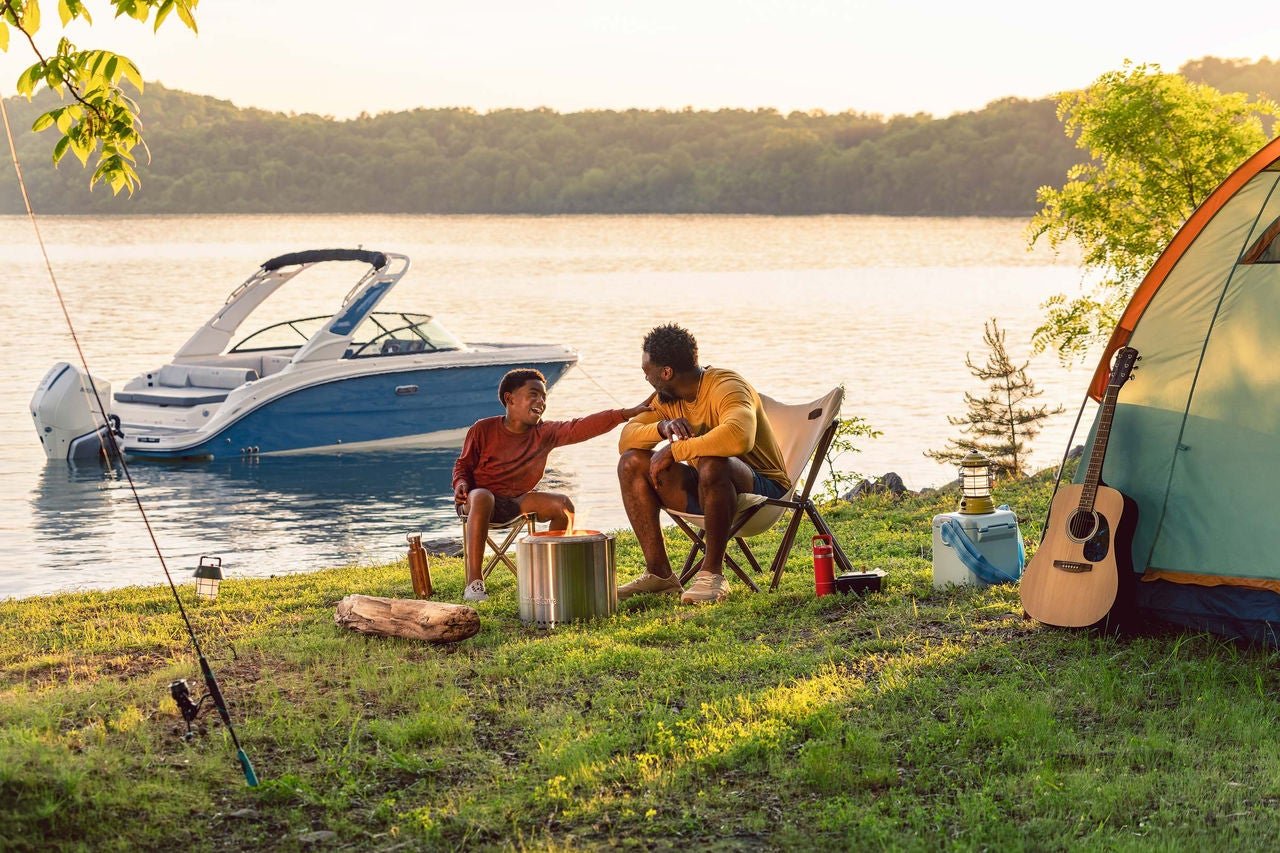 Family at a campsite next to an SDX 230 Outboard