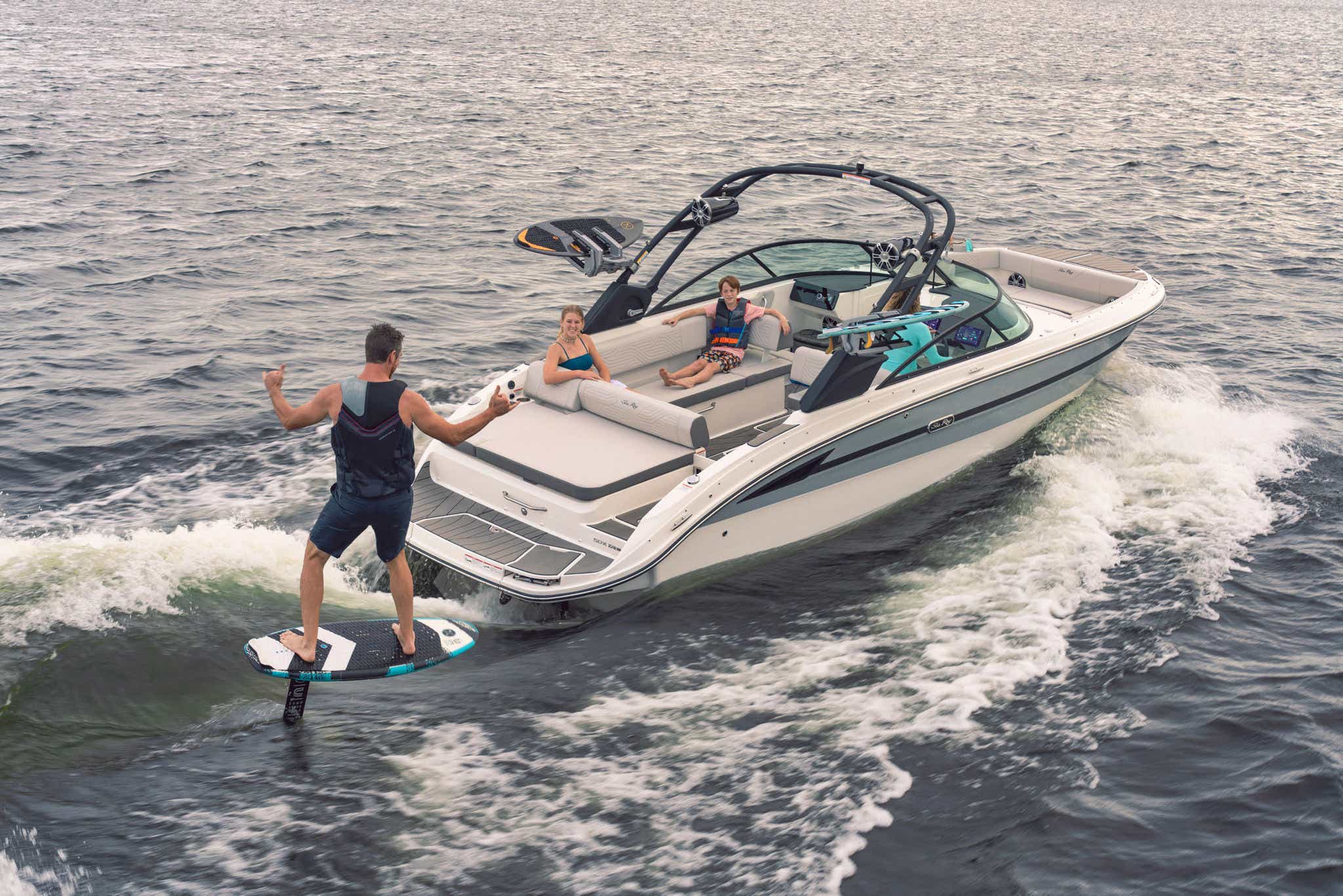 Man foilboarding behind an SDX 270 Surf