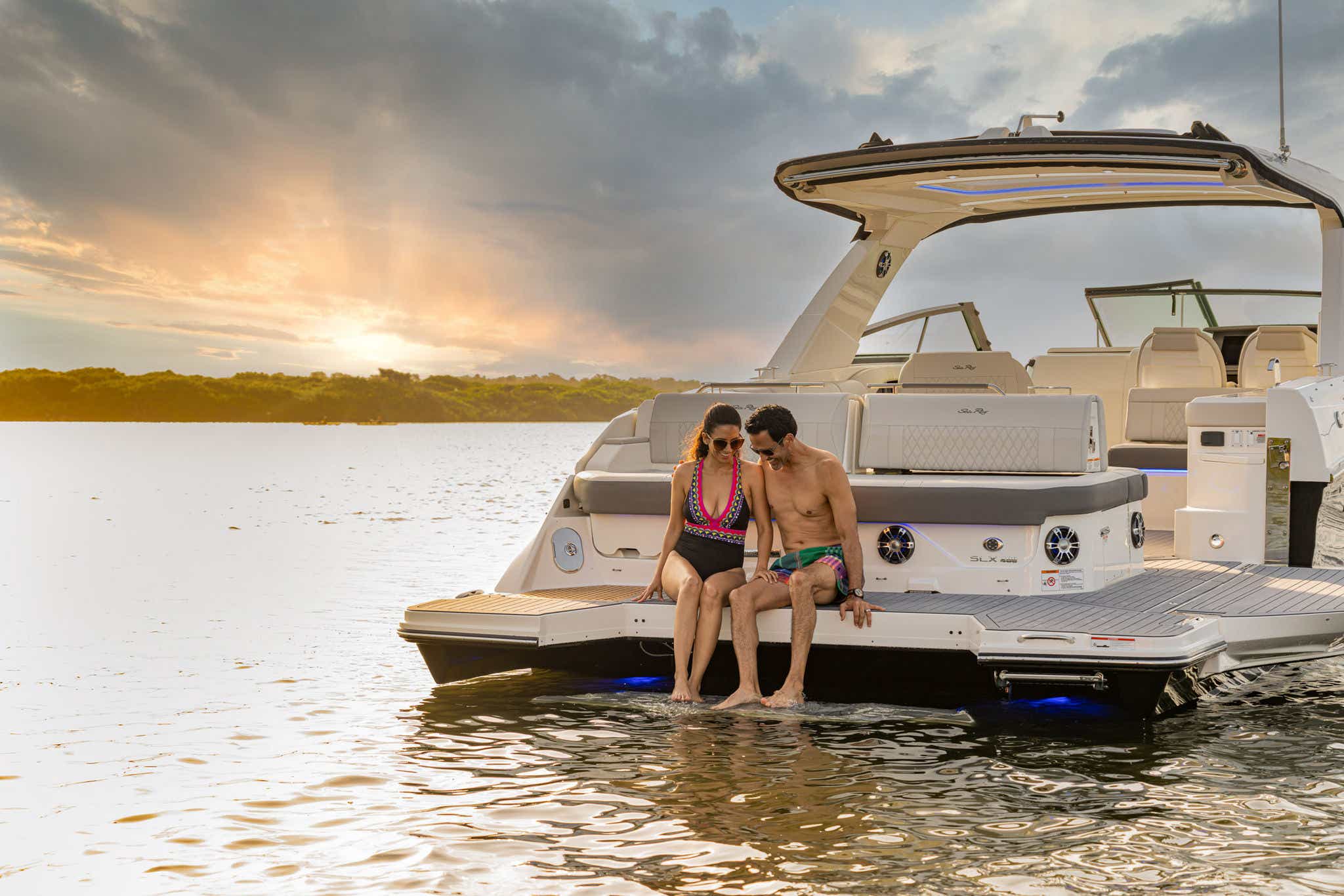 Couple using swim platform of 2024 SLX 400