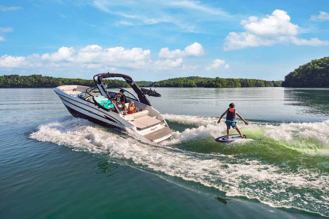 Kid wakesurfing behind an SDX 230 Surf