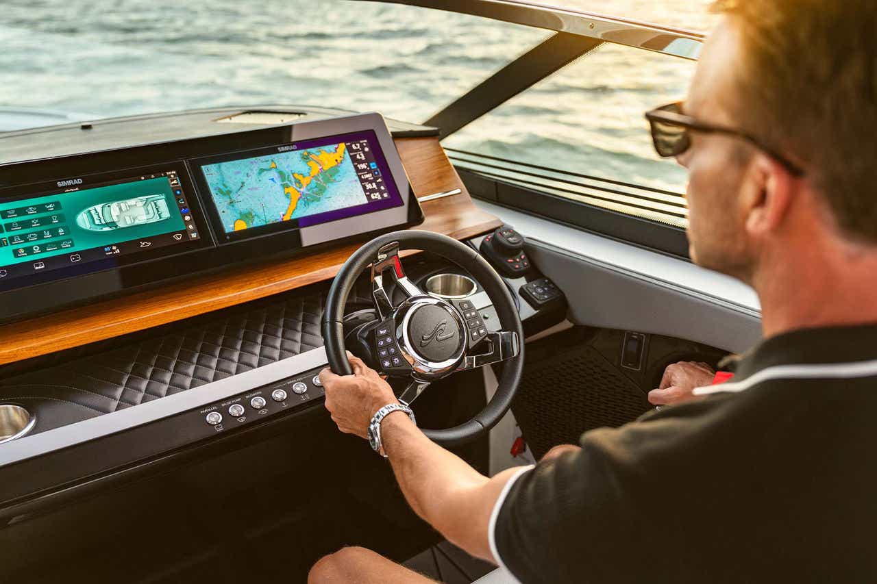 Man at the helm of an SLX 360 Outboard