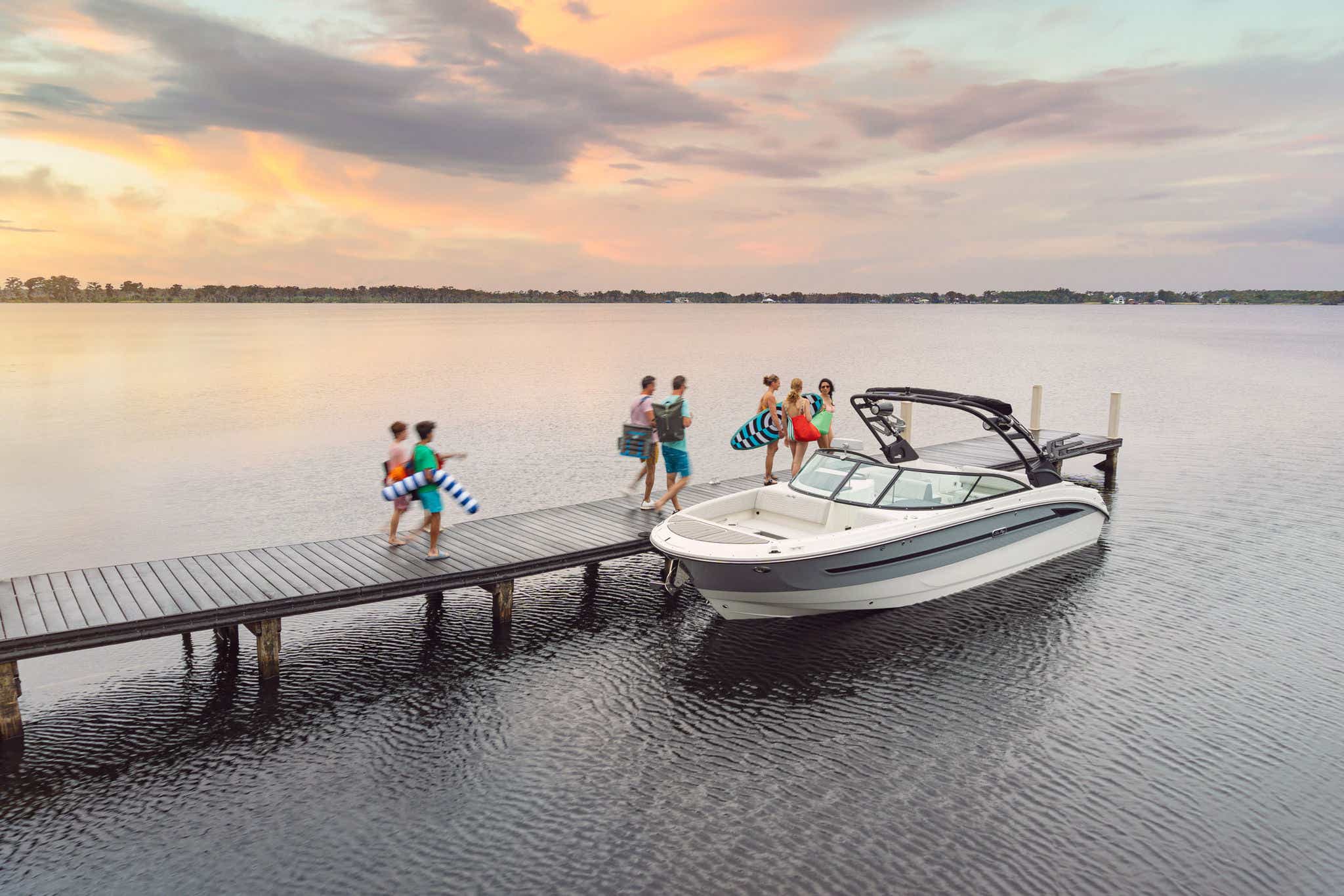People walking on a dock toward an SDX 270 Surf