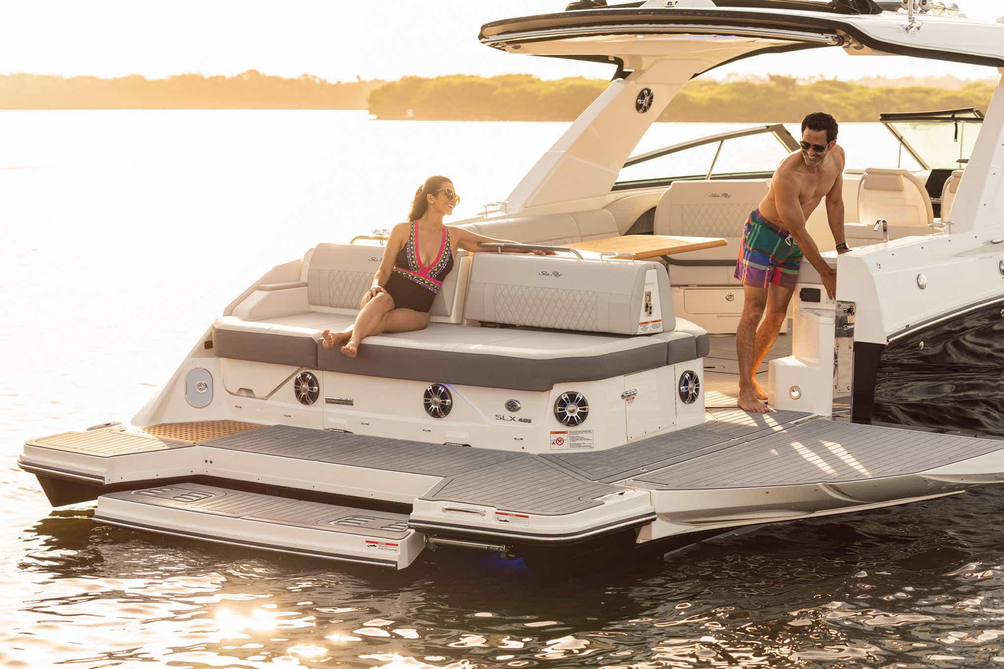 Couple using swim platform of 2024 SLX 400