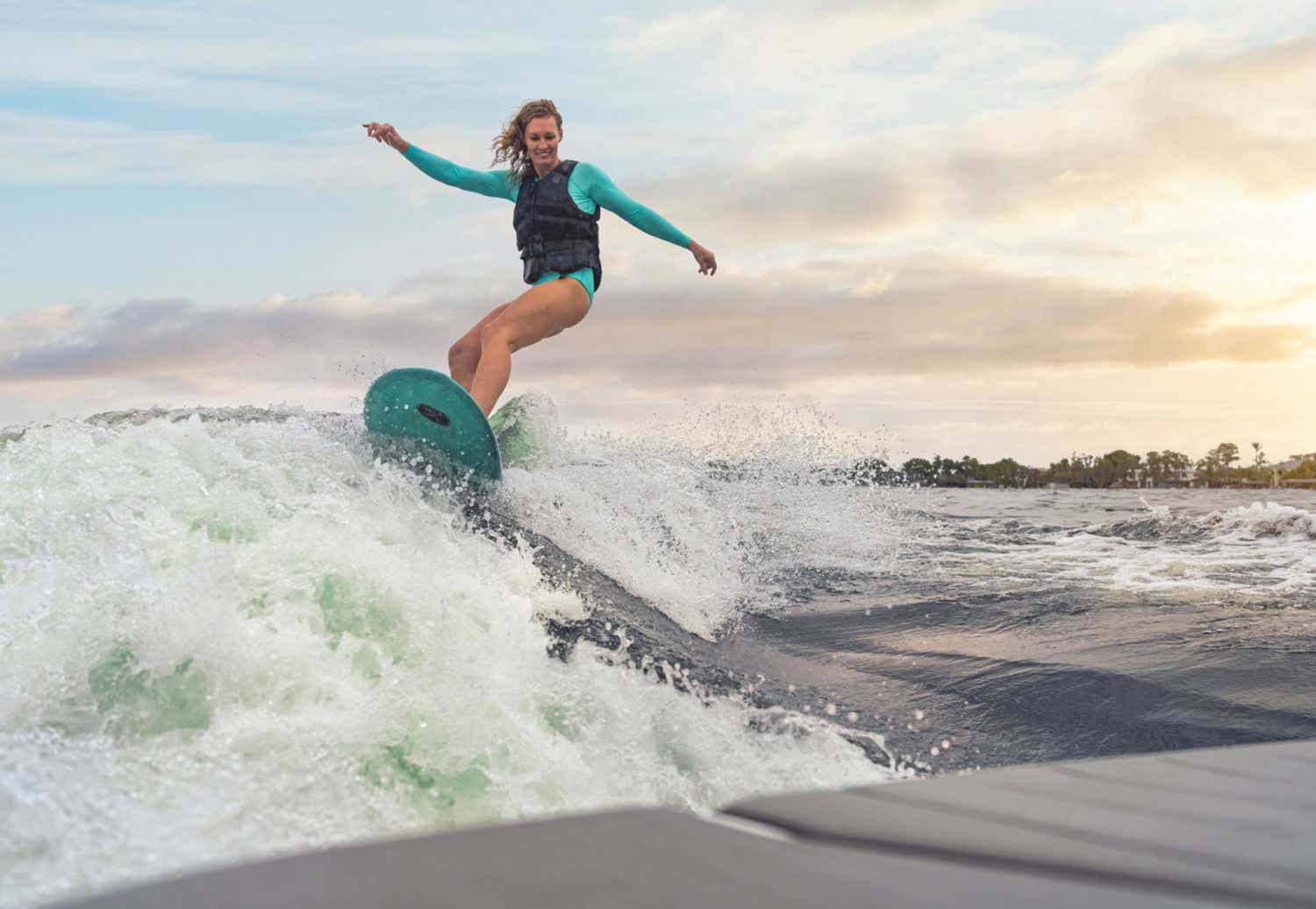 Woman surfing on Sea Ray SDX 270
