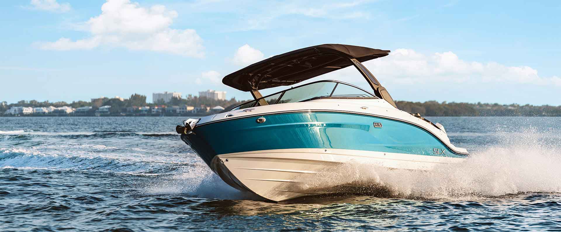 A light blue Searay SLX on the water