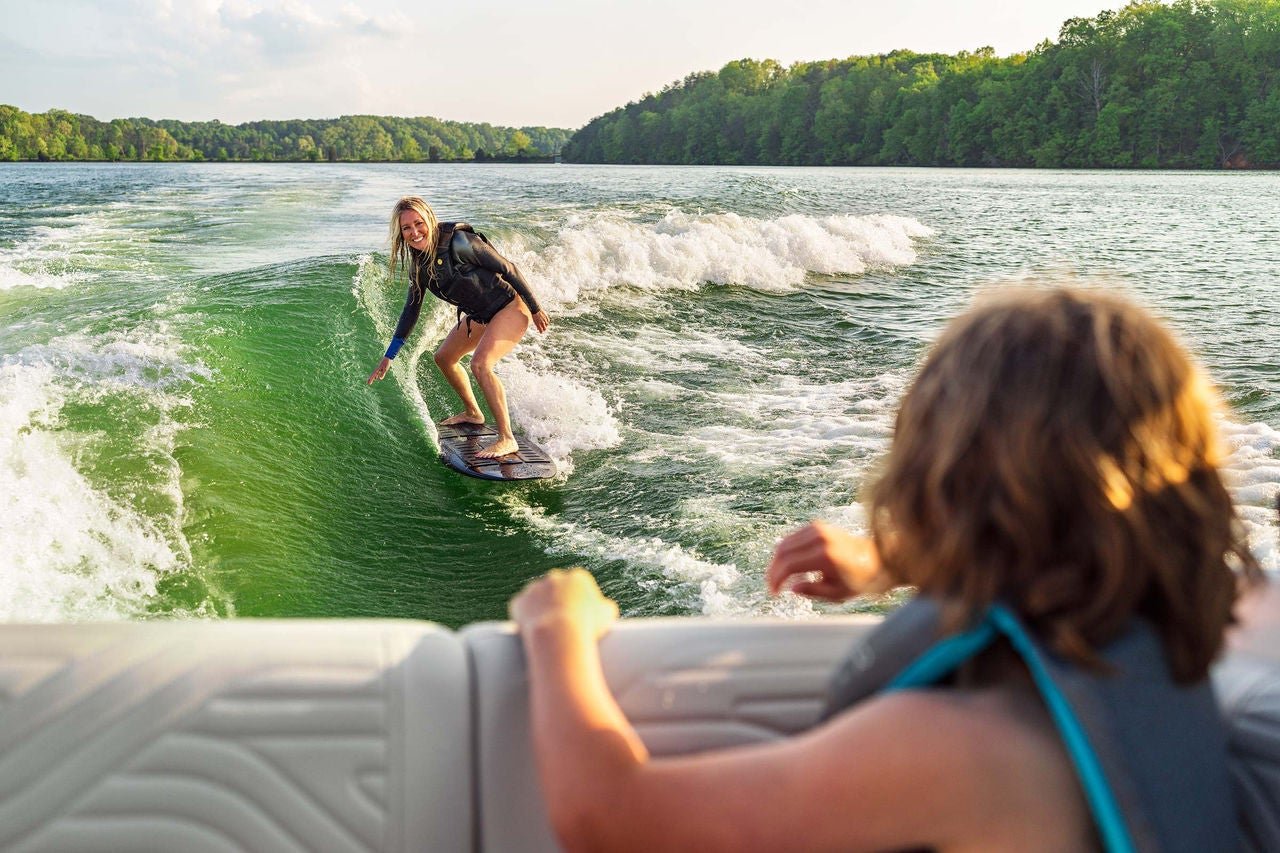 Woman wakesurfing behind an SDX 230 Surf