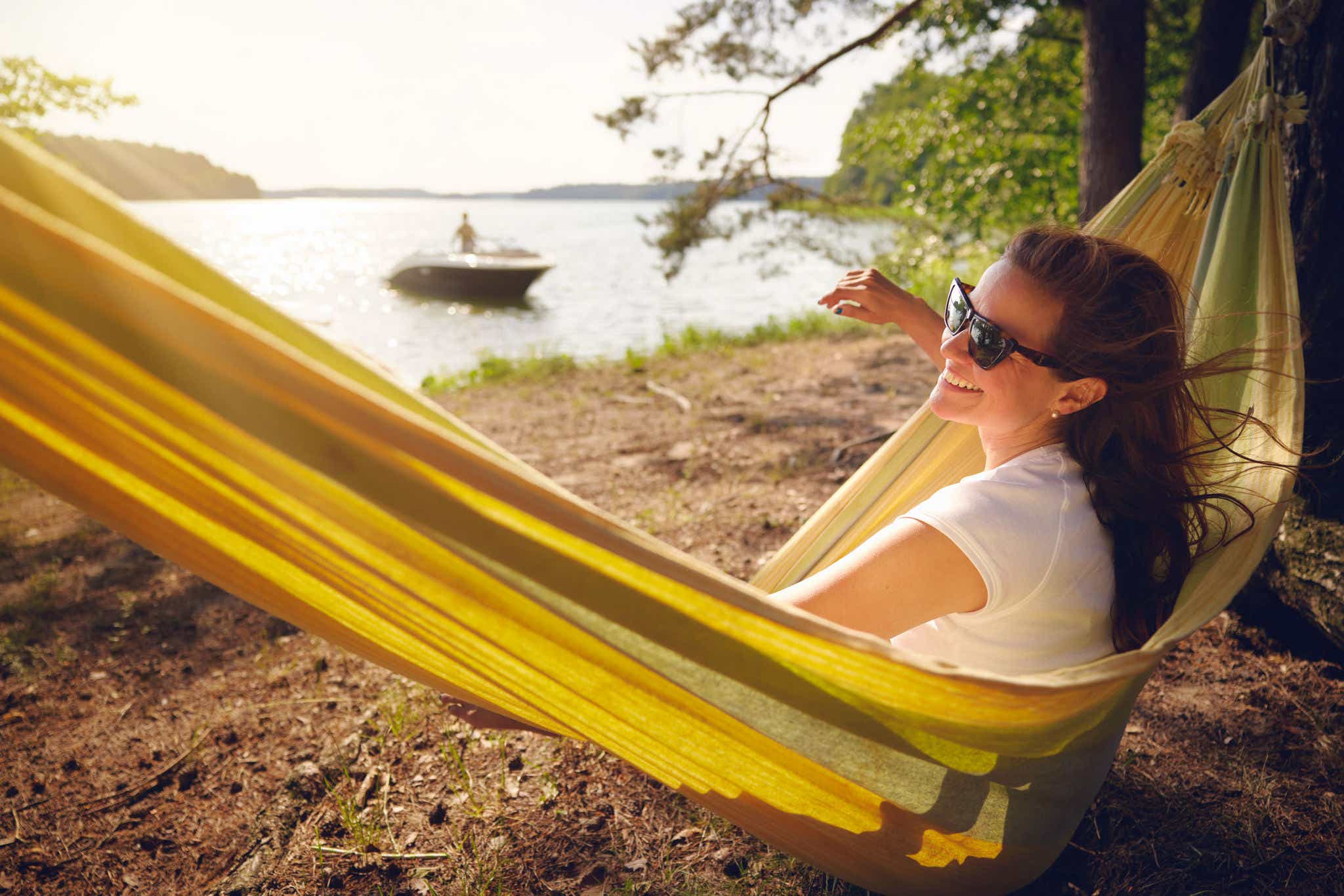 Smiling woman in a hammock at a campsite next to an SPX 190
