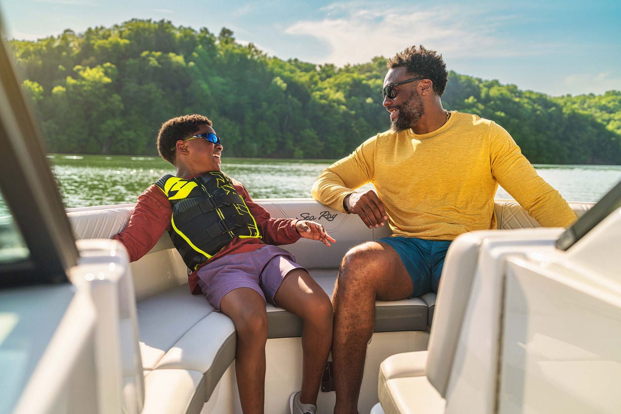 Family sitting in the bow of an SDX 230 Outboard