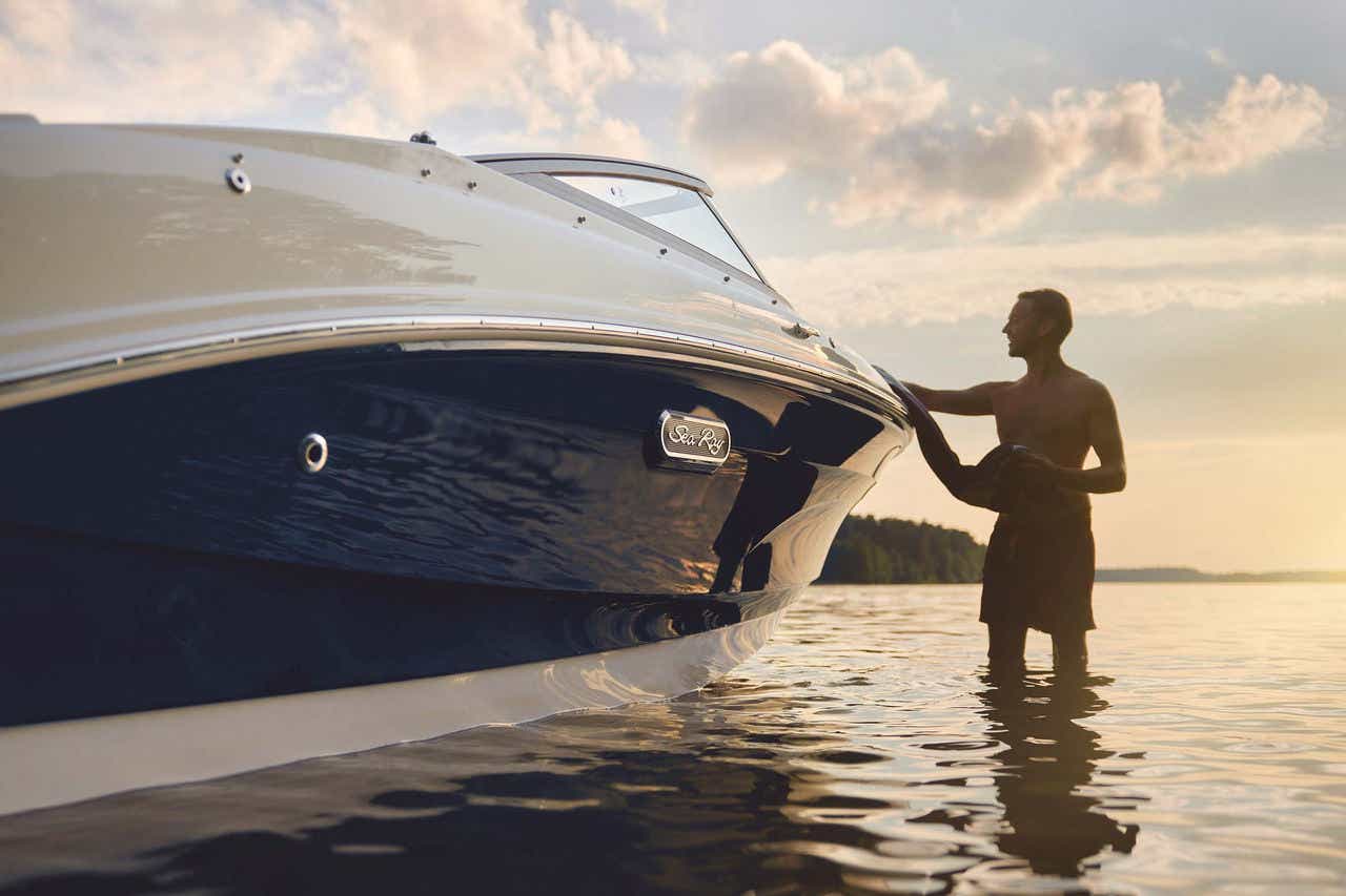 Man next to an SPX 190 Outboard at sunset