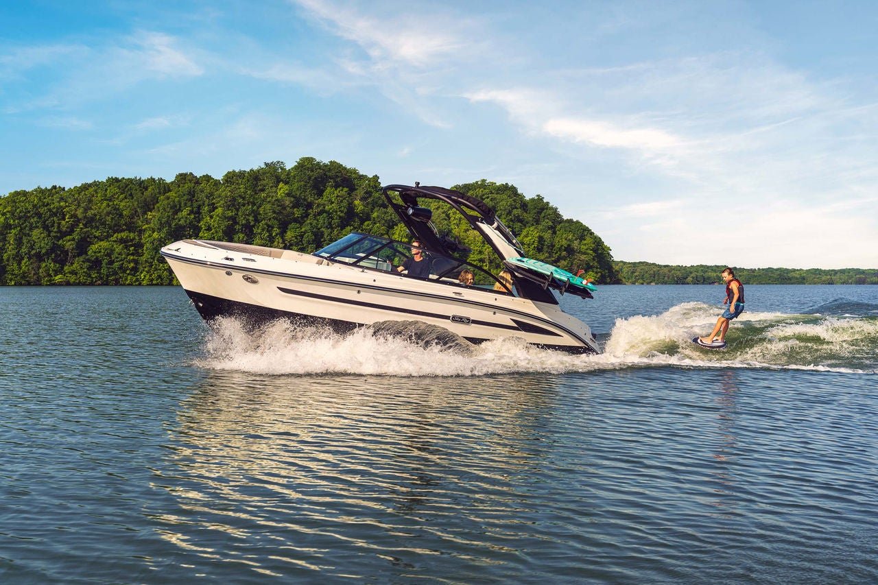 Kid wakesurfing behind an SDX 230 Surf