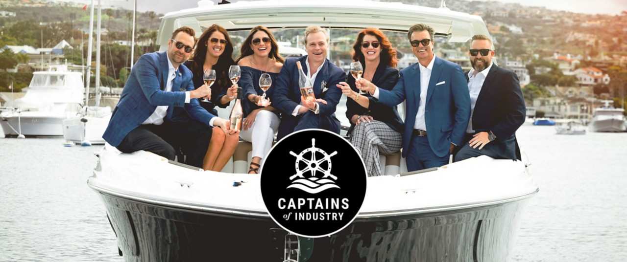 captains-of-industry-toasting-champagne-boat