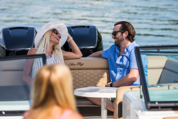 Woman and Man Relaxing in Sea Ray SDX 290 Outboard Boat