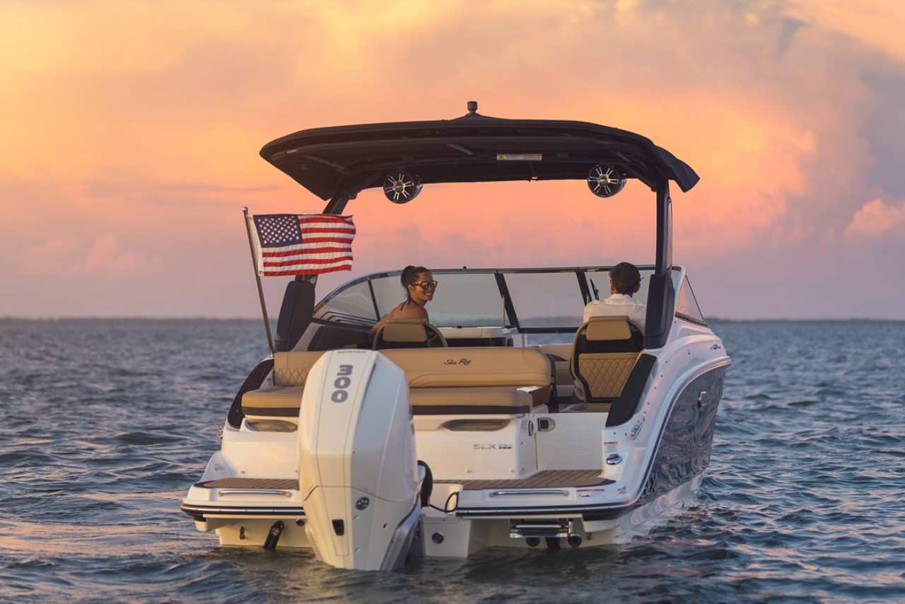 SLX 260 Outboard starboard stern couple flag sunset
