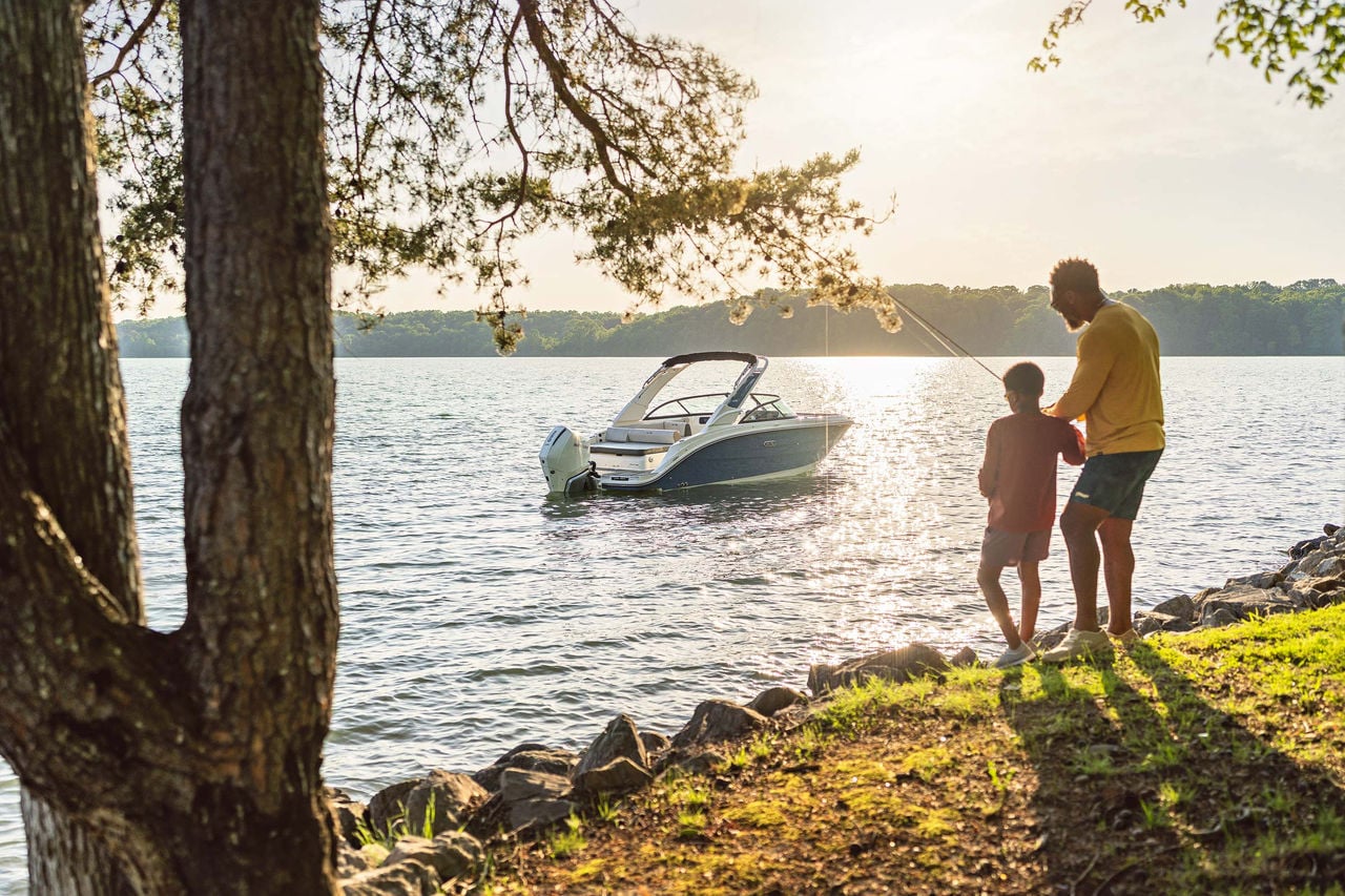 Family fishing next to an SDX 230 Outboard