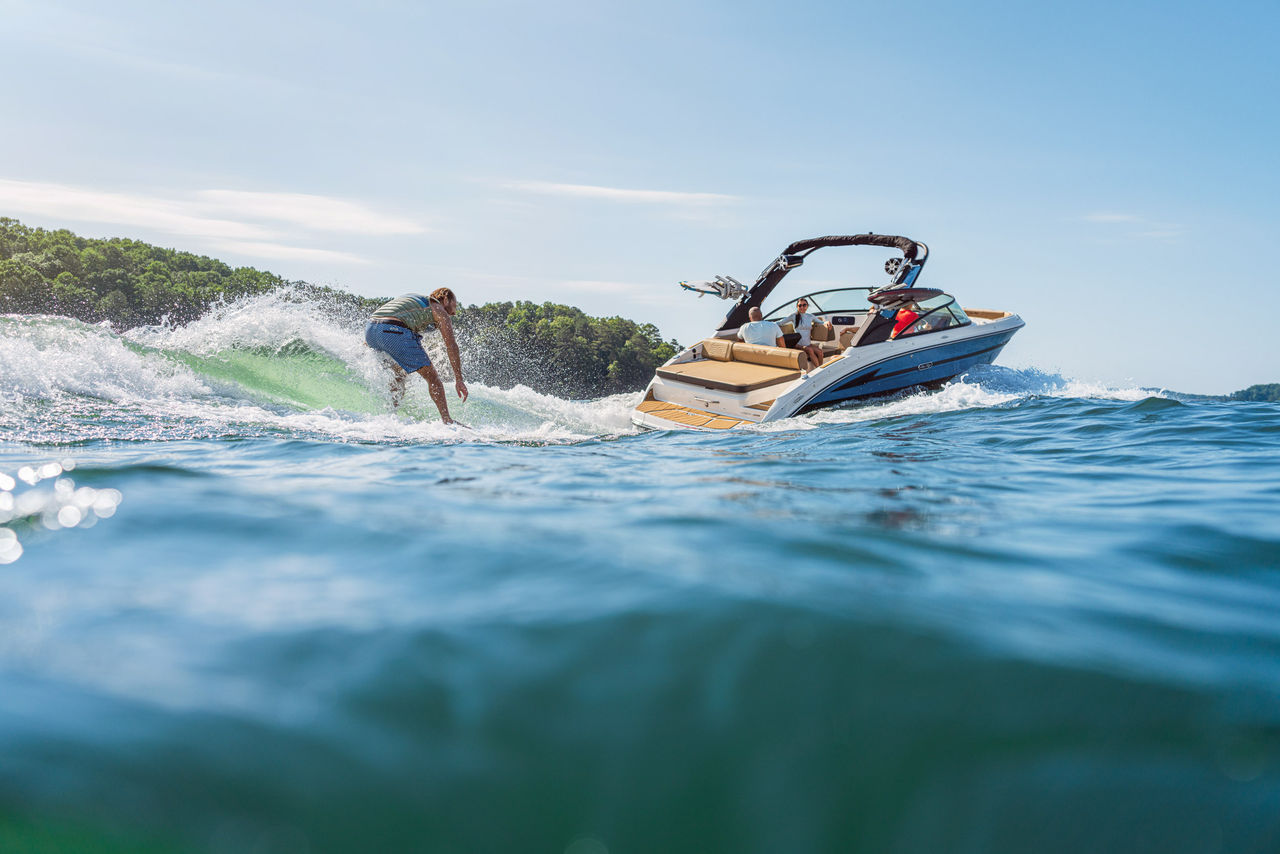 Man wakesurfing behind an SDX 250 Surf