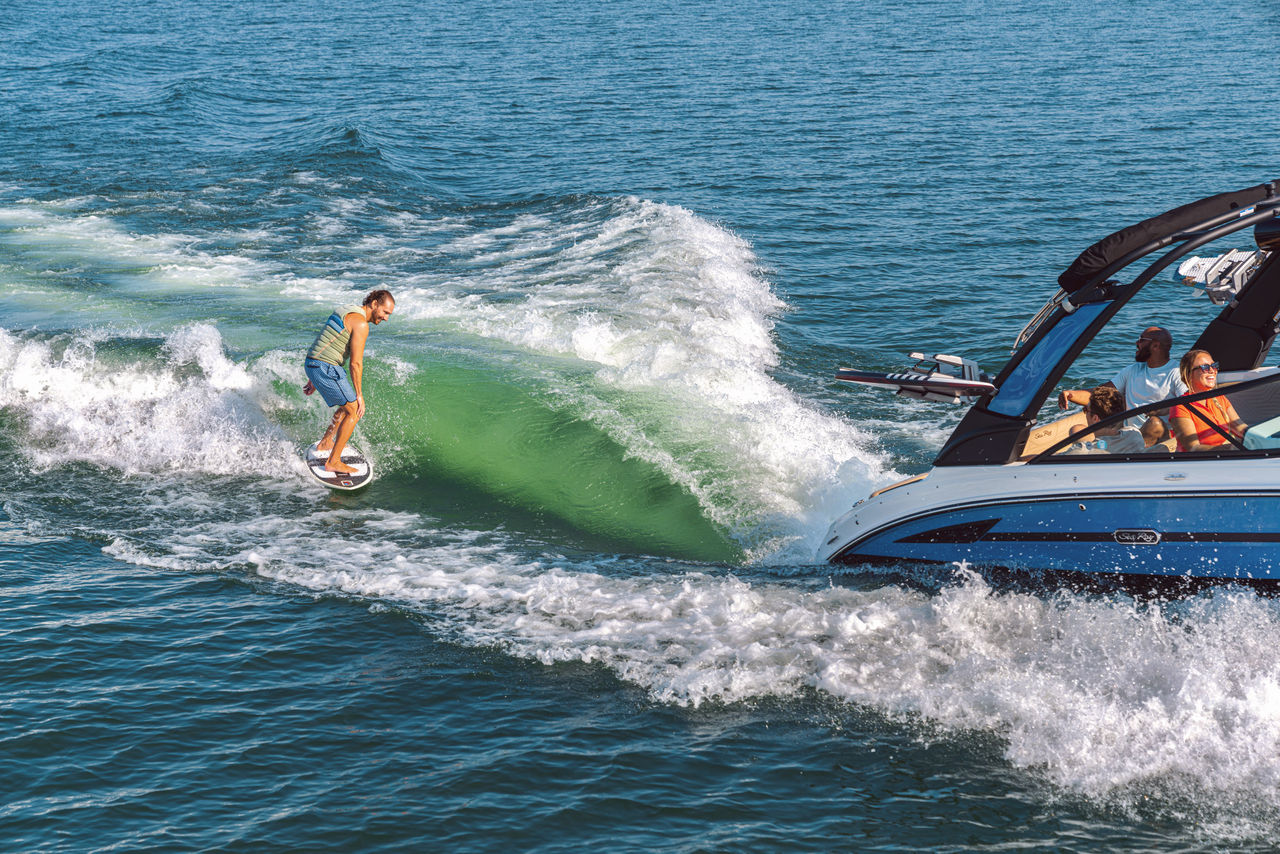 Man wakesurfing behind an SDX 250 Surf
