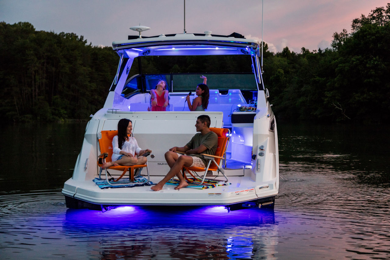 2024 Sundancer 320 and family dancing with underwater lighting