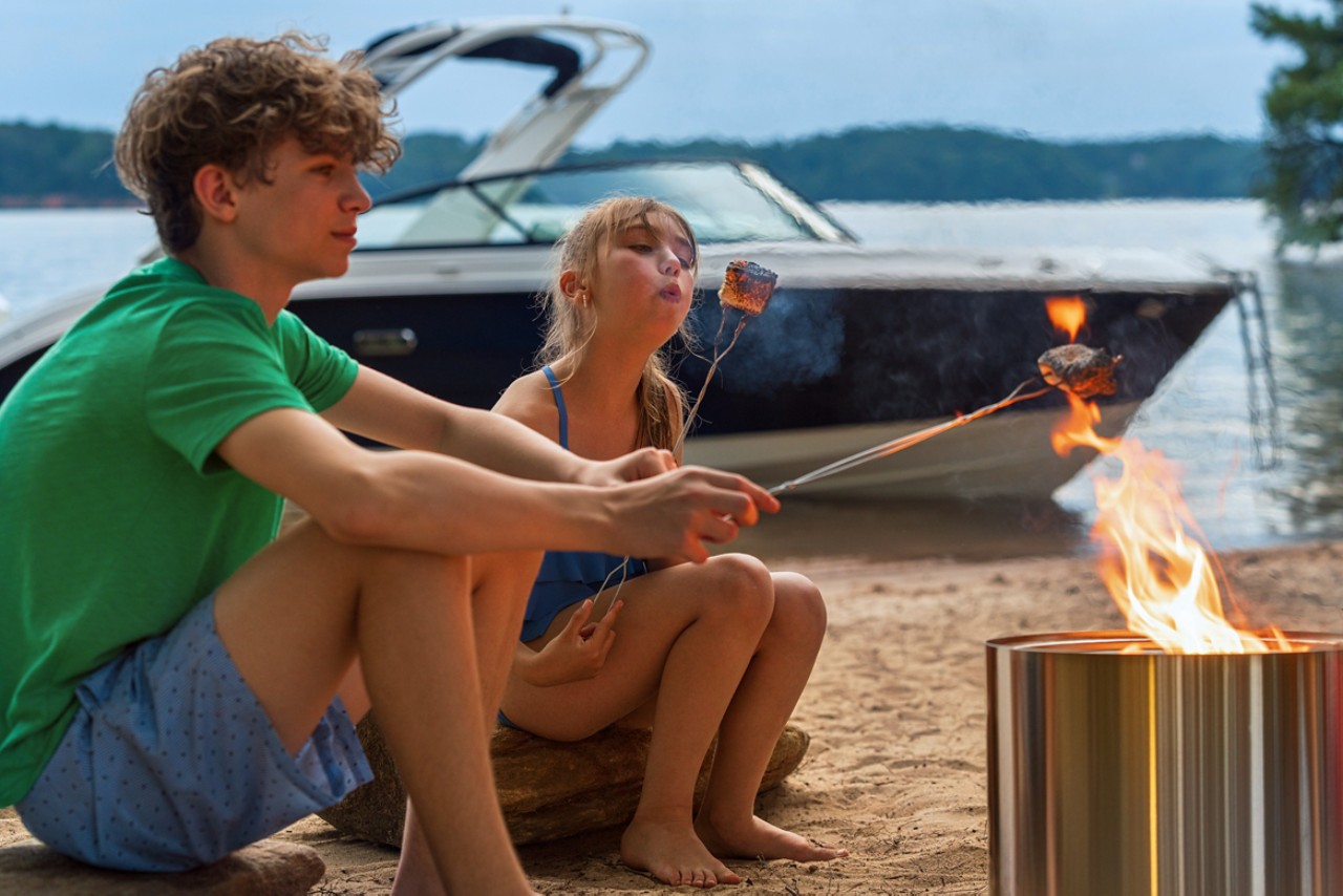 Kids at a campsite next to an SDX 250 Outboard