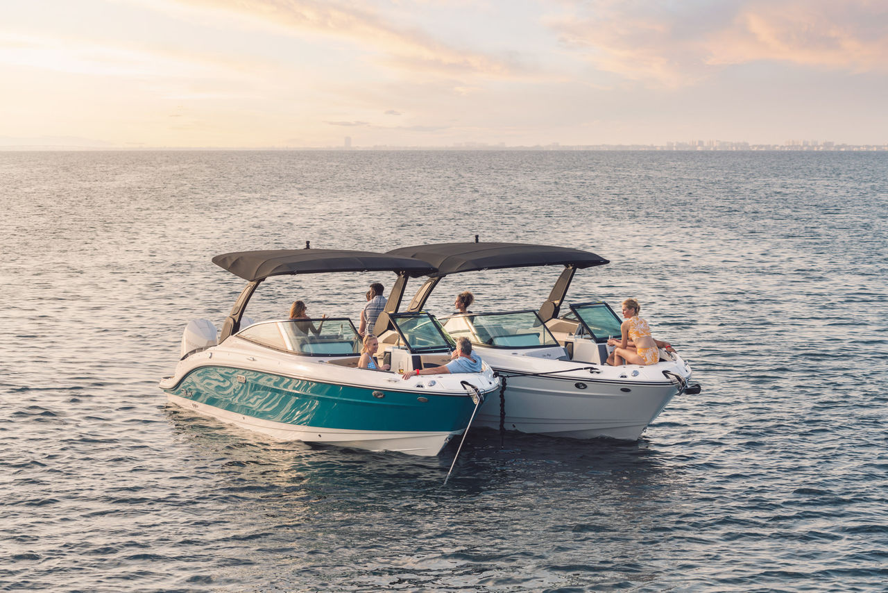 Friends aboard an SLX 280 and SLX 280 Outboard