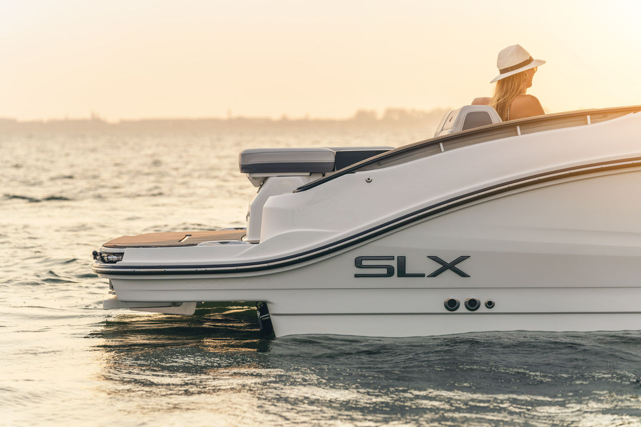 Woman aboard an SLX 280 at sunset
