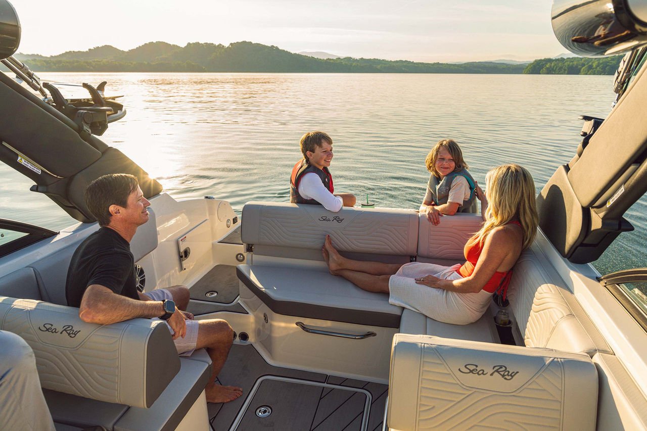 Family aboard an SDX 230 Surf at sunset