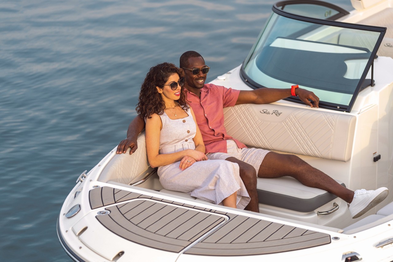 Couple sitting in the bow of an SDX 270 Outboard