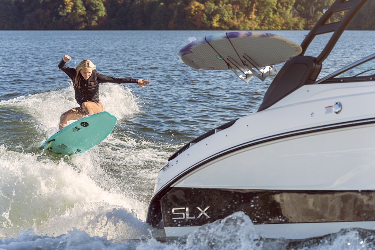 Woman wakesurfing behind an SLX 260 Surf