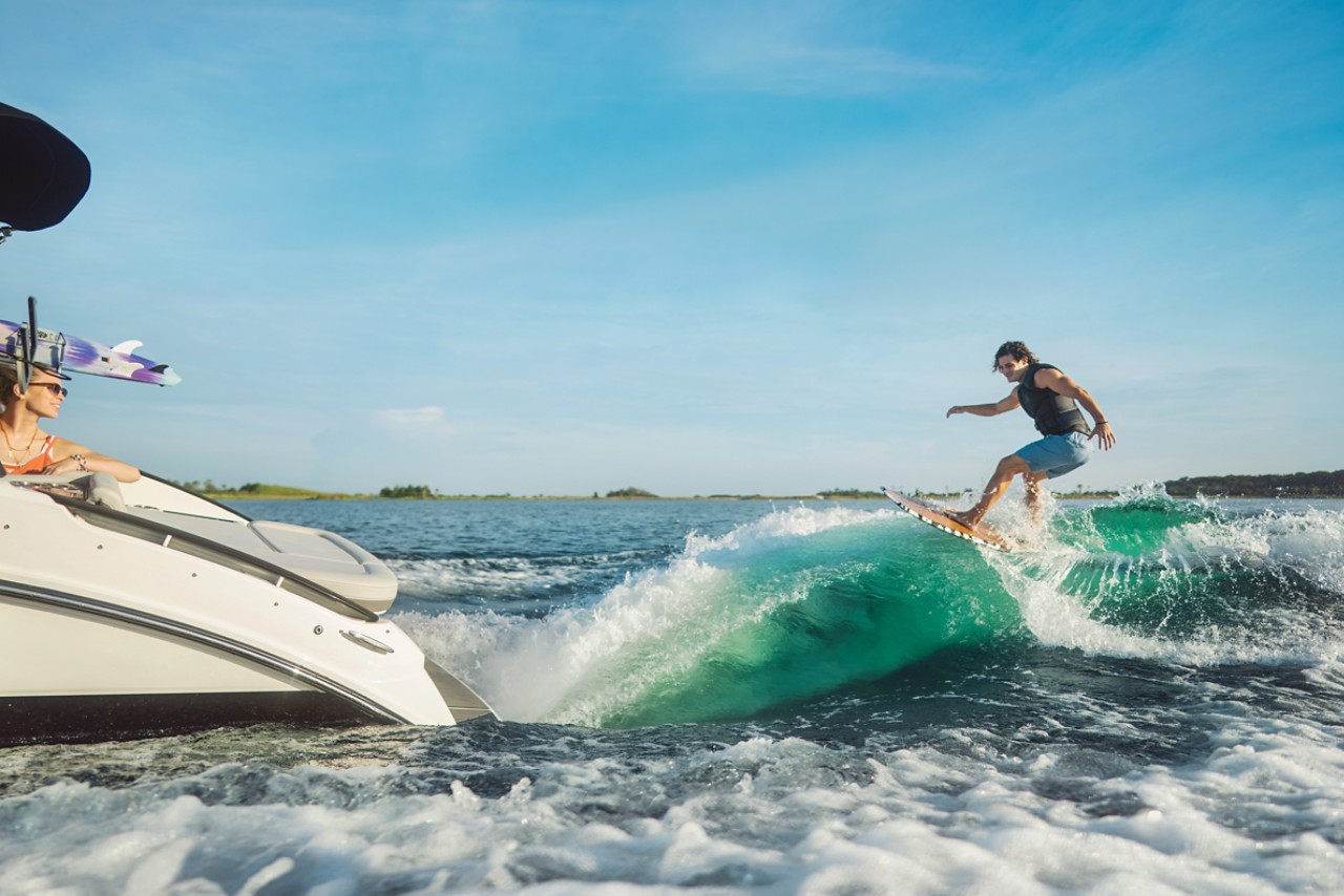 Man wakesurfing behind an SLX 260 Surf