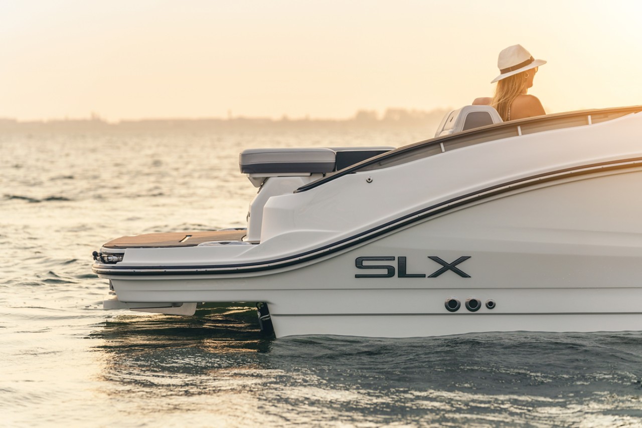 Woman aboard an SLX 280 at sunset