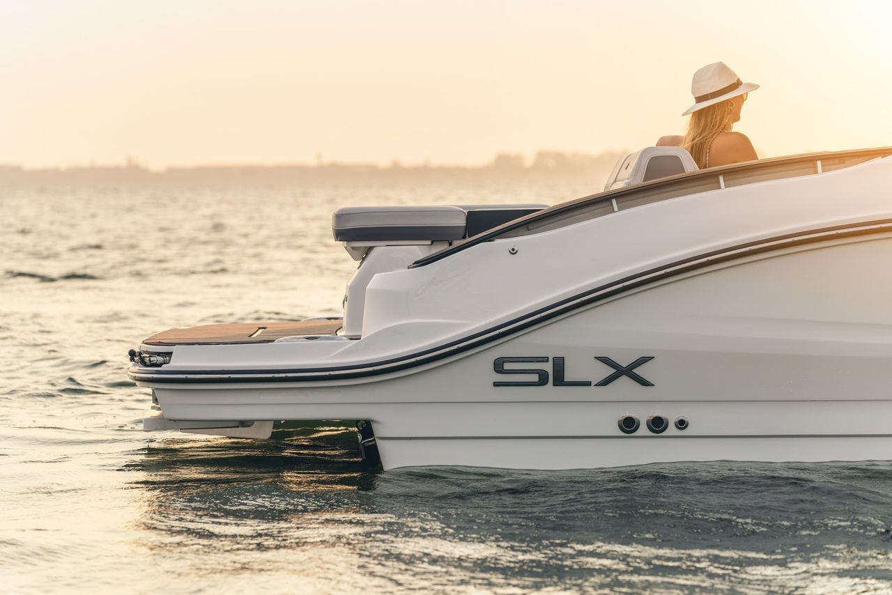 Woman aboard an SLX 280 at sunset