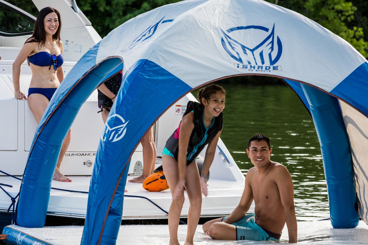 2024 Sundancer 320 and family in life jackets using swim platform